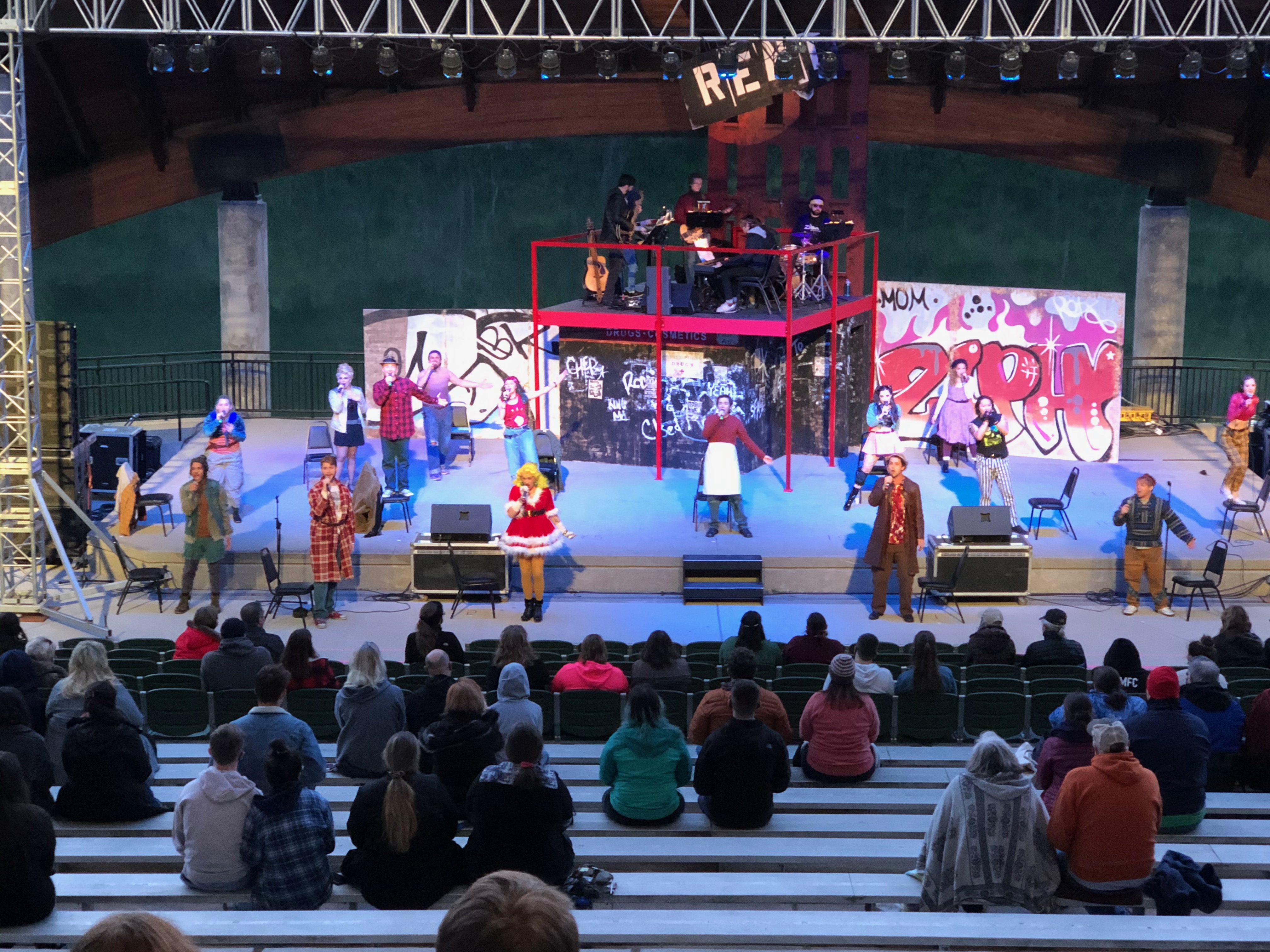 A performance of RENT on stage at the Hazel Ruby McQuain Amphitheatre