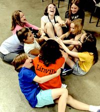 Youth theatre kids playing on the floor